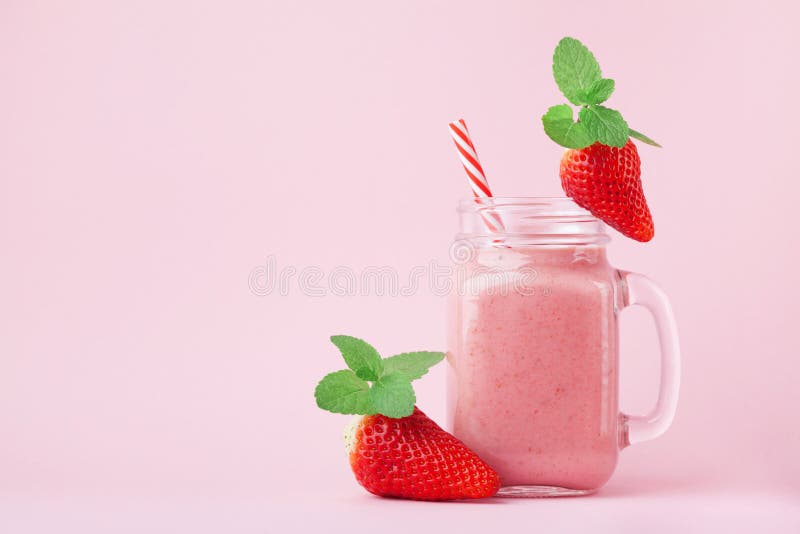 Pink strawberry smoothie or milkshake in mason jar decorated mint on pastel background. Healthy food for breakfast and snack. stock images Pink strawberry smoothie or milkshake in mason jar decorated mint on pastel background. Healthy food for breakfast and snack. stock images