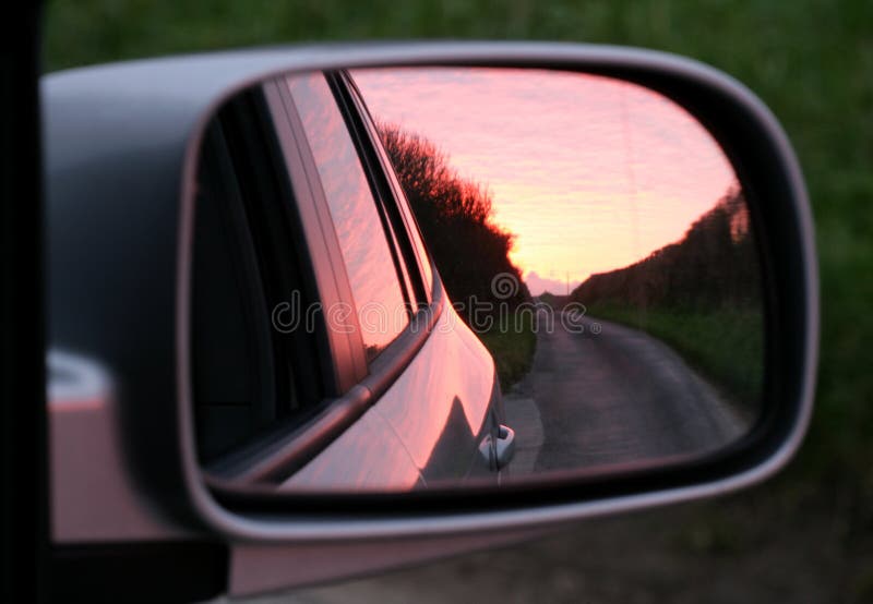 Pink sunset in rear view mirror