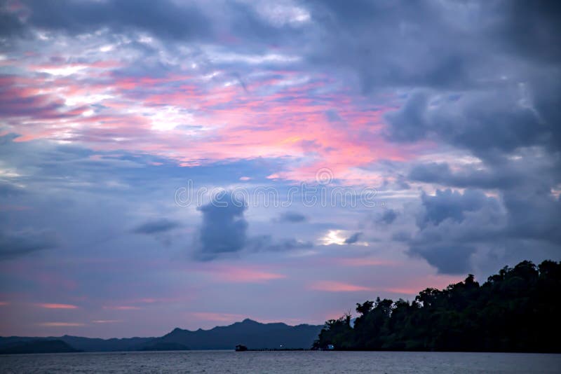 A pink sunset on a stormy sky on the Raja Ampat islands