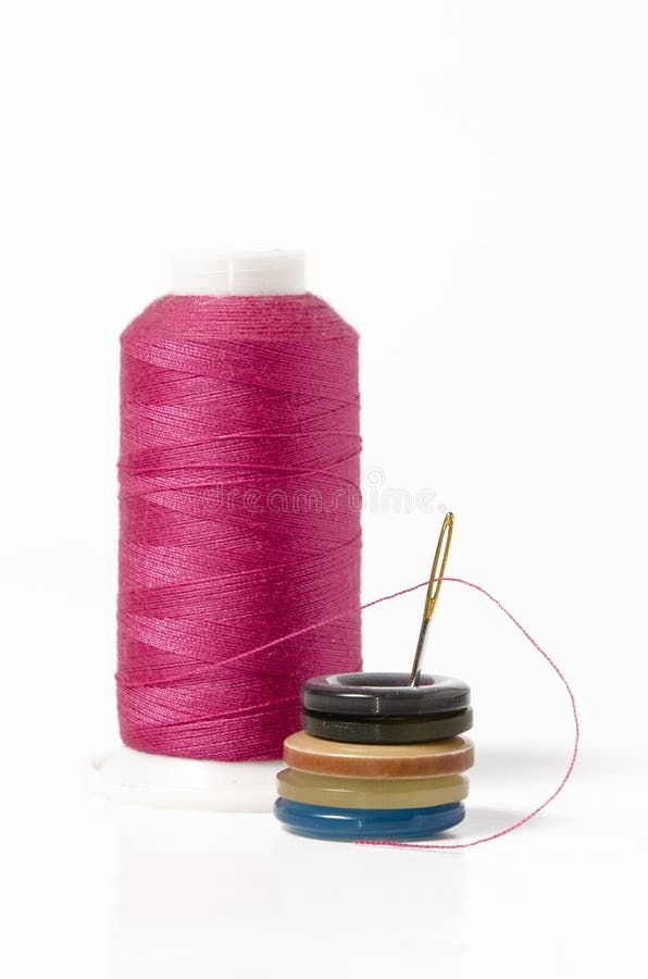 Pink thread with needle and buttons