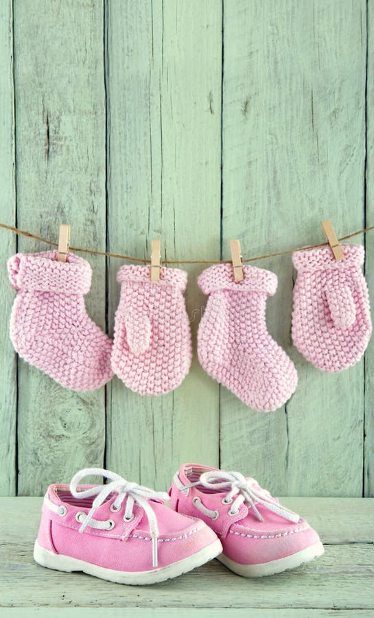 Pink toddler shoes on light green background. Pink toddler shoes on wooden light green vintage background with copy space royalty free stock photos Pink toddler shoes on light green background. Pink toddler shoes on wooden light green vintage background with copy space royalty free stock photos