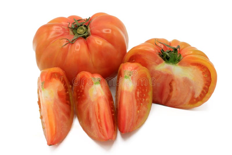 Pink Tomato Cut into Chunks, Isolated on a White Background Stock Image