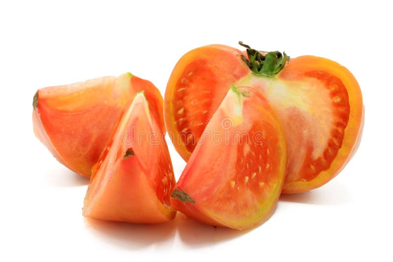 Pink Tomato Cut into Chunks, Isolated on a White Background Stock Photo
