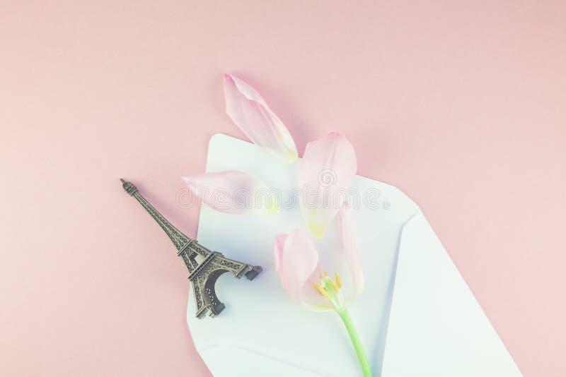 Pink tulip in envelope with eiffel tower miniature