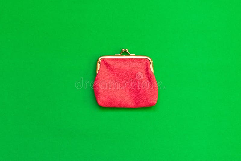 Pink wallet green background. The concept of savings. Top view.