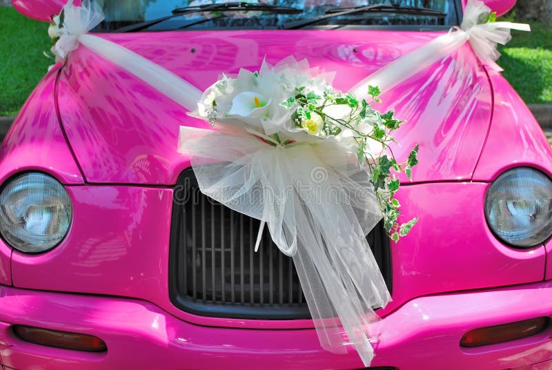 Pink wedding car with bouquet of flowers