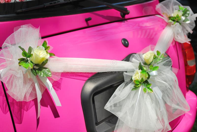 Pink wedding car with flower decorations