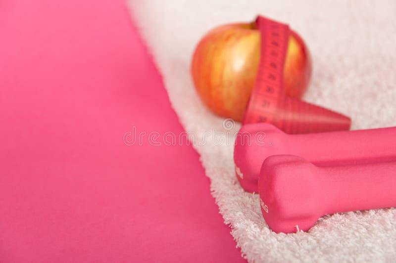 Pink weights on white towel