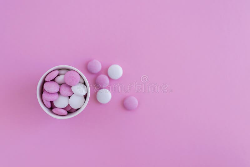 Pink and White Round Candies in Cup on Pink Background Stock Image