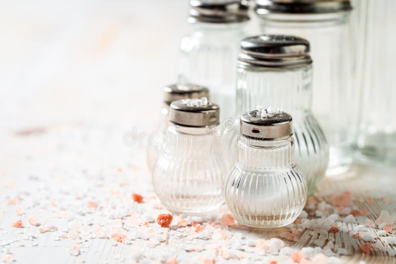 Pink and White Salt in Salt Shaker on White Table Stock Photo Image