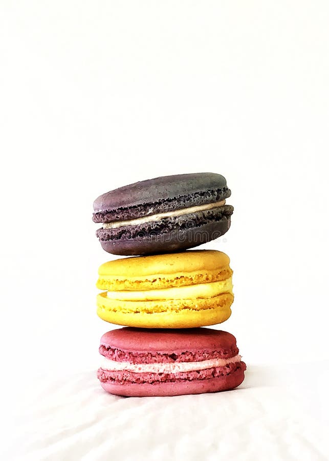 Pink, Yellow, and Purple Macaroons Stacked with a Textured White ...