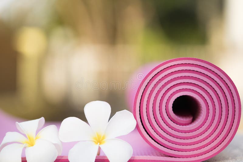 Pink Yoga Mat and a Flower Outdoor, Healthy and Sport Concept Stock