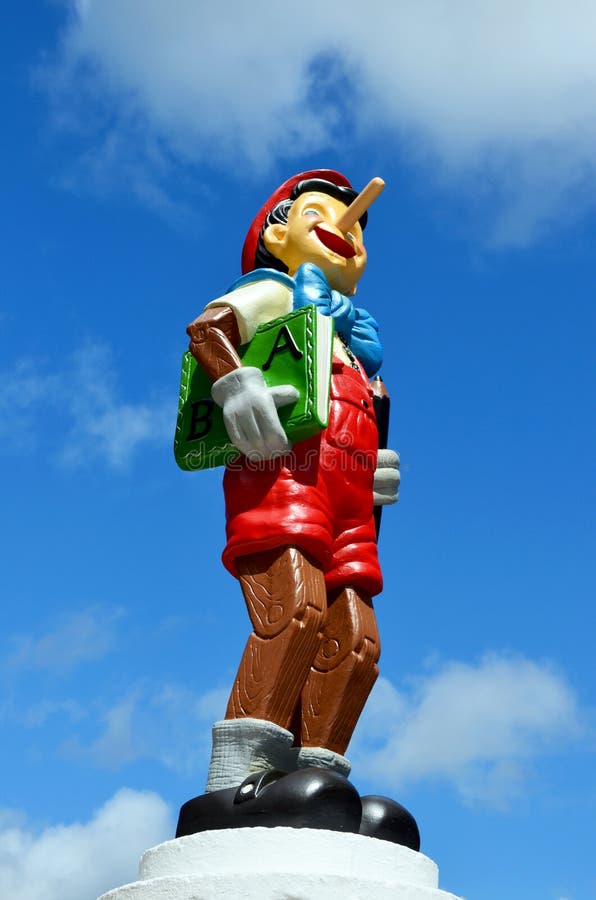 Pinocchio figure Standing on a plympth holding a book. This figure is part of a huge private collection of life size Disney display figures. Pinocchio is a 1940 American animated film produced by Walt Disney and based on the story The Adventures of Pinocchio by Carlo Collodi