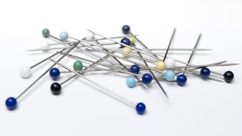 Heap of multi-coloured sewing pins on a white background, Stock image