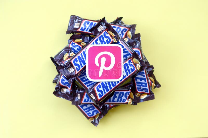 Pinterest paper logo on many Snickers chocolate covered wafer bars in brown wrapping. Advertising chocolate product in Pinterest