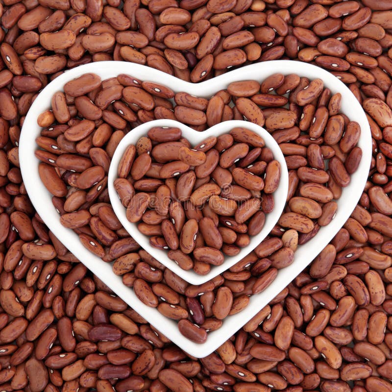 Pinto bean health food in heart shaped bowls forming an abstract background. Pinto bean health food in heart shaped bowls forming an abstract background.