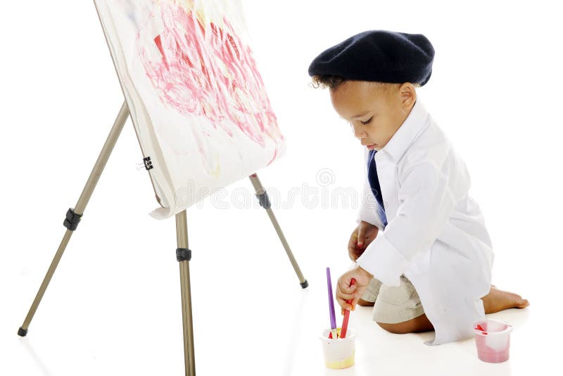 An adorable preschooler painting on an easel in his smock and French baret. On a white background. An adorable preschooler painting on an easel in his smock and French baret. On a white background.