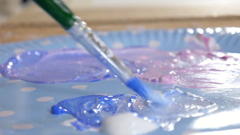 Pintura de las mujeres adultas con las pinturas acrílicas coloreadas en un cierre de la escuela de arte para arriba