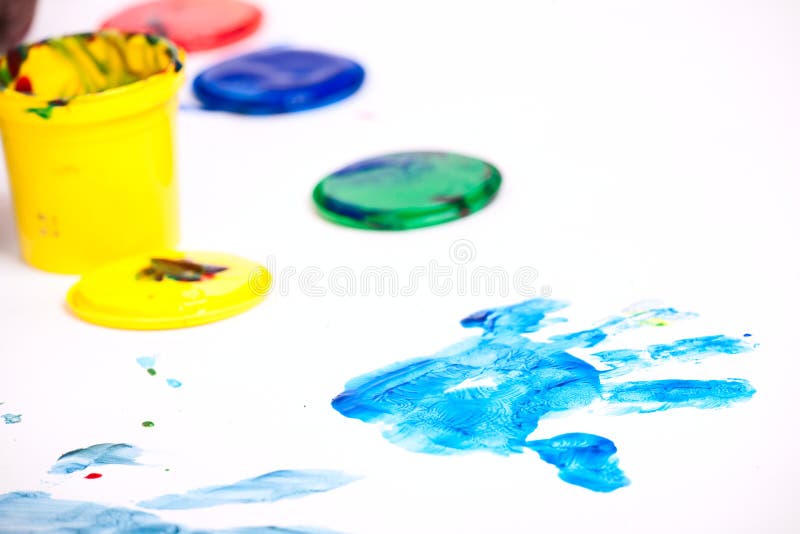 Closeup of colorful finger paints over white background. Closeup of colorful finger paints over white background