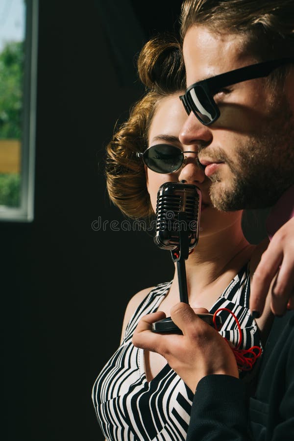 Pinup girl and man sing karaoke, radio. stock photos Pinup girl and man sing karaoke, radio. stock photos
