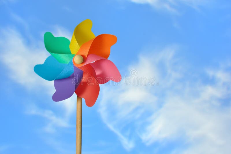 A child's pinwheel against a blue sky. Shot outside with studio lighting - not a composite. A child's pinwheel against a blue sky. Shot outside with studio lighting - not a composite.