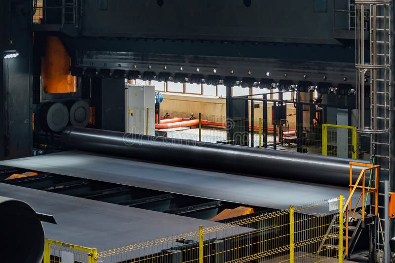 Pipe Formation by Using Roll Bending Machine, Close Up Stock Photo