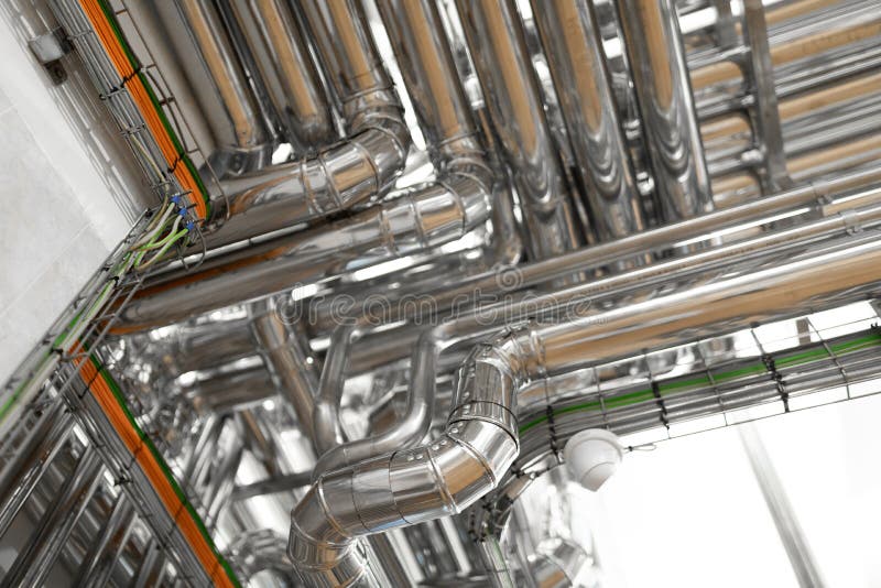 Bright Wires And Chrome Pipes. Industrial Background Stock Photo