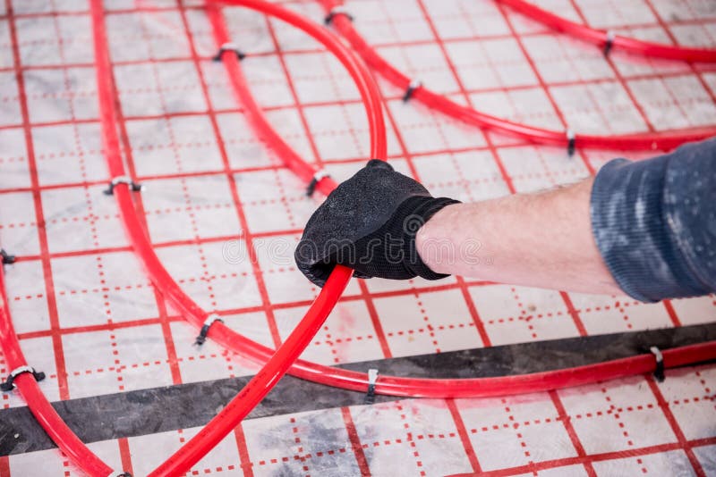 Pipefitter Install System of Underfloor Heating System at Home Stock