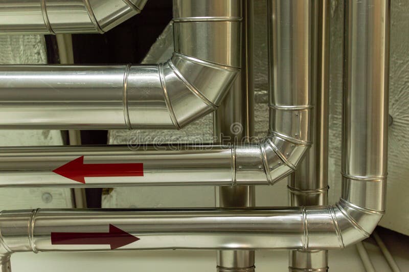 Pipes of HVAC System Hung from the Ceiling. Heating System on the Roof