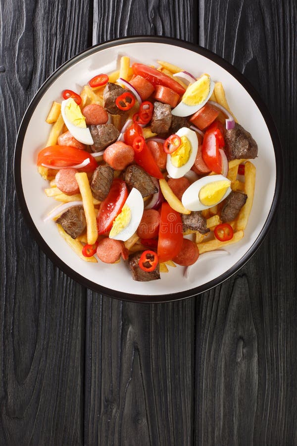 Pique Macho is a Very Popular Dish from Bolivia Made of Beef Cuts and Fried  Sausages with Fries, Eggs, Chili Peppers and Tomatoes Stock Photo - Image  of appetizer, fillet: 225522920