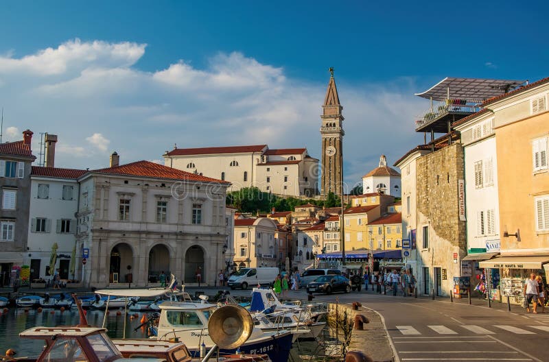 Harbour of Piran, Slovenia. Historic old buildings and St. George s Parish Church with italian campanile on the hill