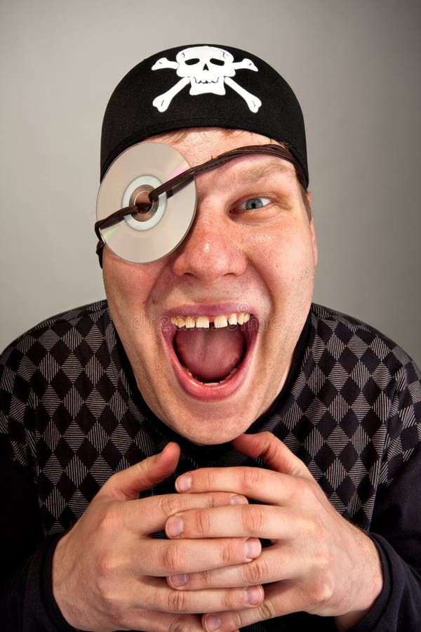 Pirate with computer disk on eye stock image Pirate with computer disk on eye stock image