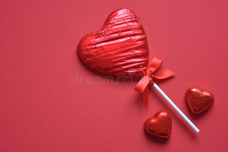 Pirulito vermelho isolado no fundo vermelho liso imagens de stock royalty free Pirulito vermelho isolado no fundo vermelho liso imagens de stock royalty free