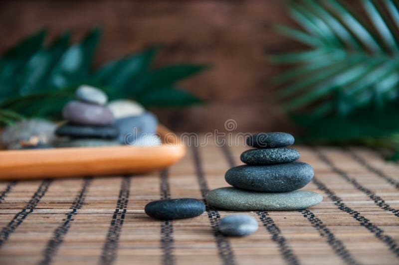 Pirâmides de pedras cinzentas do zen com folhas e a estátua verdes da Buda O conceito da harmonia, do equilíbrio e da meditação, fotos de stock Pirâmides de pedras cinzentas do zen com folhas e a estátua verdes da Buda O conceito da harmonia, do equilíbrio e da meditação, fotos de stock