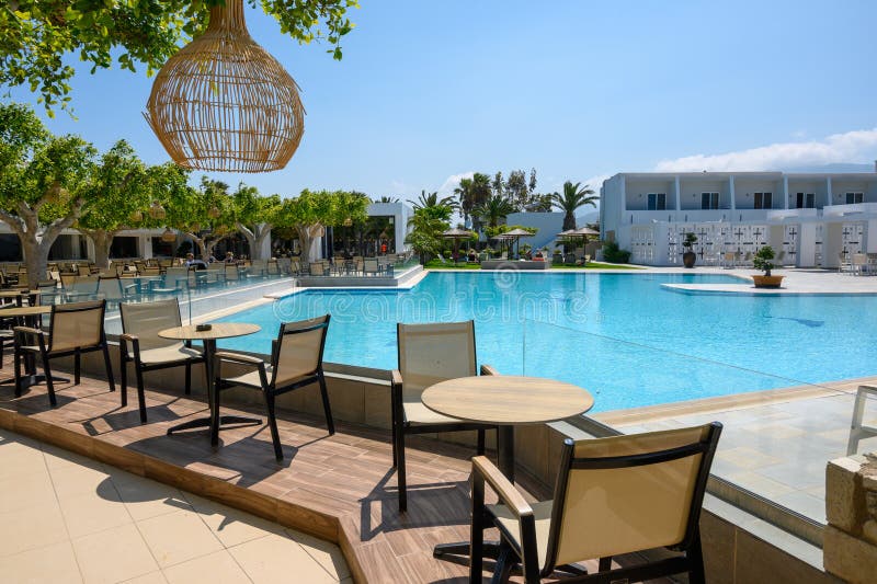 Kos, Greece - May 13, 2023: Pool area of the Sandy Beach hotel, a 4-star resort in Marmari village on the island of Kos. Greece. Kos, Greece - May 13, 2023: Pool area of the Sandy Beach hotel, a 4-star resort in Marmari village on the island of Kos. Greece