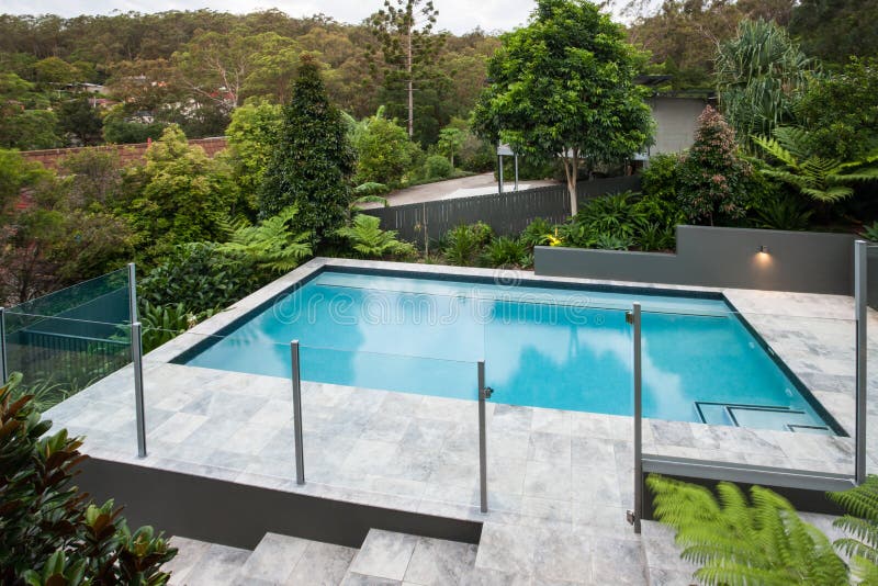 Piscine moderne avec une barrière en verre sur le plancher images libres de droits Piscine moderne avec une barrière en verre sur le plancher images libres de droits