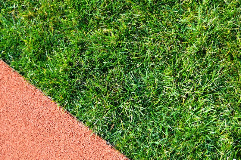 Pista e hierbas de funcionamiento del atletismo en un estadio Campeón, fondo foto de archivo Pista e hierbas de funcionamiento del atletismo en un estadio Campeón, fondo foto de archivo