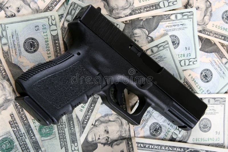 A aemi-automatic pistol on twenty dollar bills. A aemi-automatic pistol on twenty dollar bills