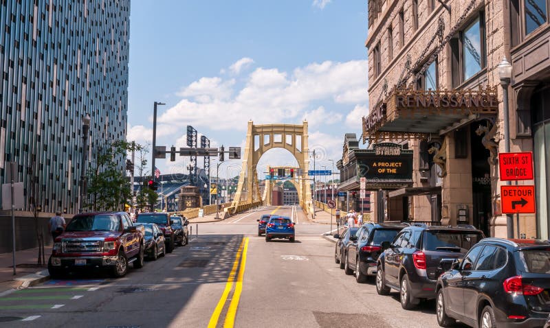 Pittsburgh, Pennsylvania, USA June 6, 2021 Parked cars and building along 6th street leading to the Roberto Clemente bridge in downtown Pittsburgh on a sunny spring day.