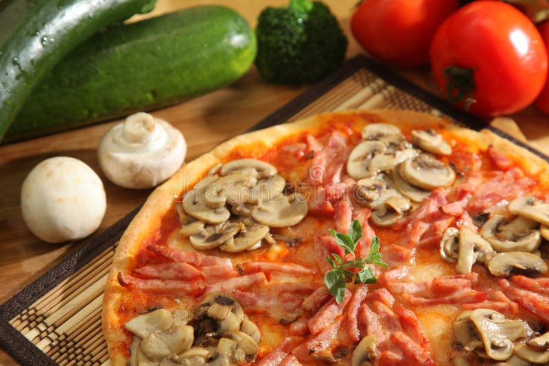 Pizza with mushrooms and tomatos