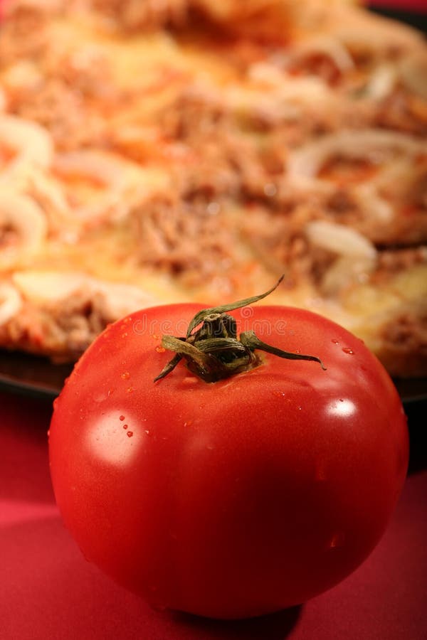 Pizza with a tomato on a red background. Dought stock images, royalty-free photos and pictures