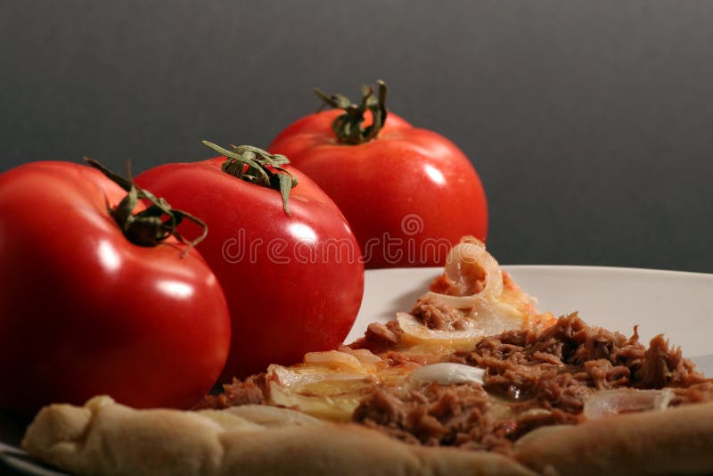 Pizza with tomatoes on a black background. Dought stock images, royalty-free photos and pictures