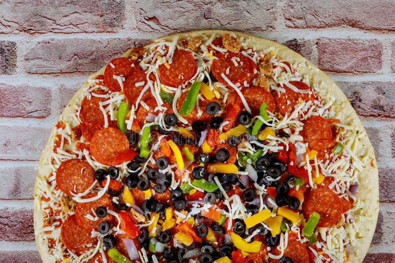 Pizza with Black Olives, Pepperoni, Sausage, Pepper and Cheese. Stock