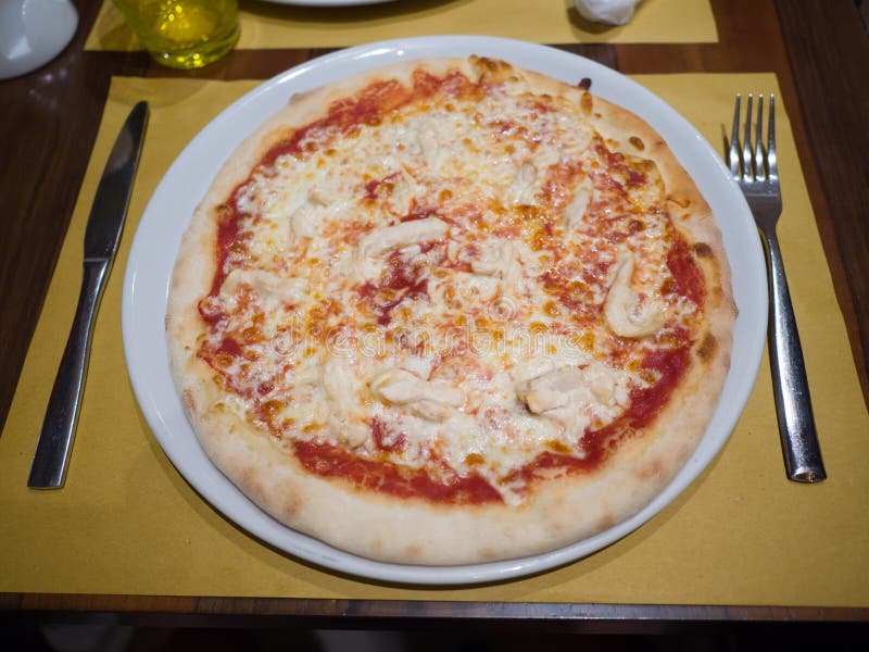 Pizza with Cheese Lies on the Table with a Fork and Knife. Stock Image