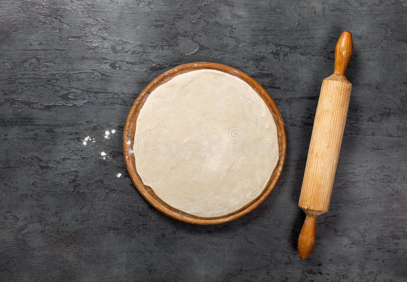 Pizza Dough on Round Wooden Board with Rolling Pin Stock Photo Image