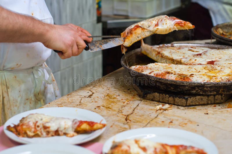 Serving hot pizza slice from the oven dish. Serving hot pizza slice from the oven dish