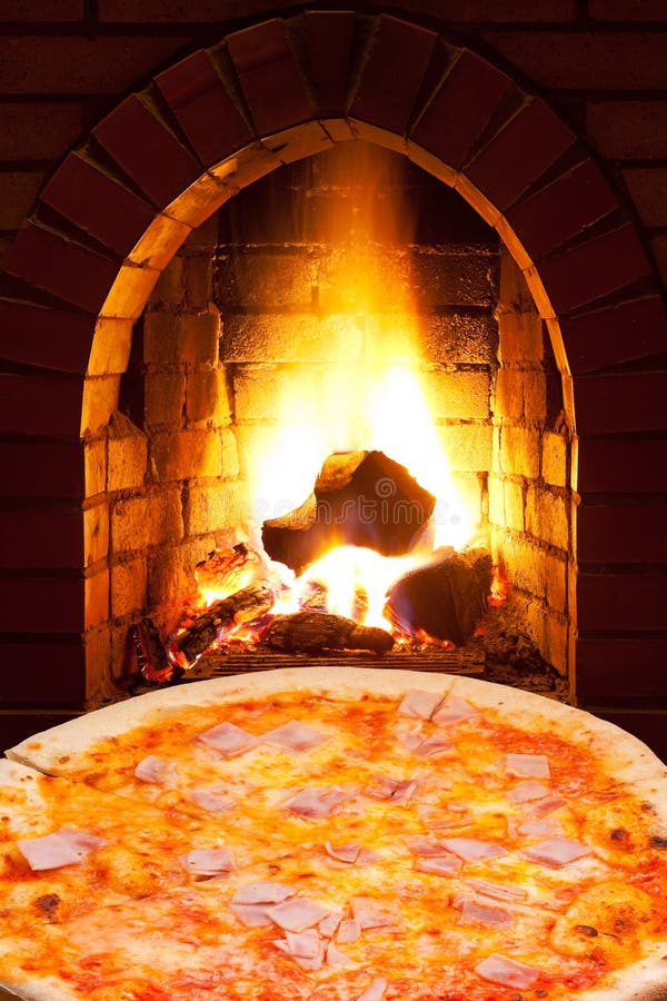 Pizza with ham and open fire in oven