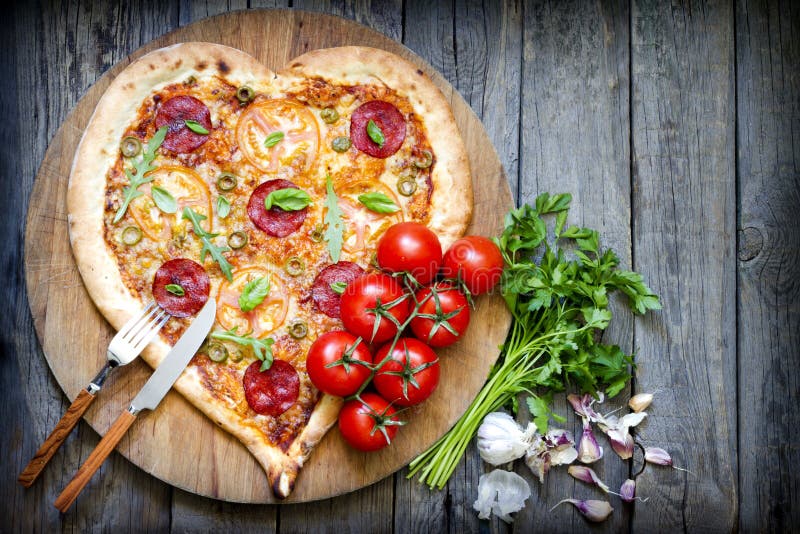 Pizza heart shape with cheese and tomato