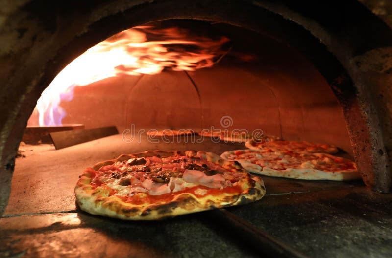 Fire and Pizza Inside an Oven in the Italian Pizzeria Stock Image