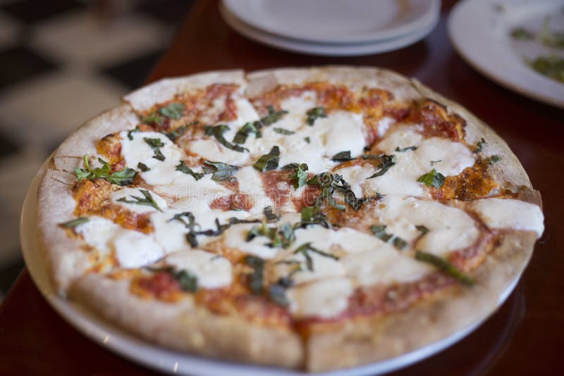 Pizza Margherita sitting on a table at a restaurant stock images Pizza Margherita sitting on a table at a restaurant stock images